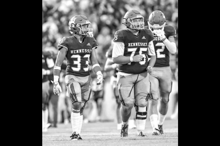 HENNESSEY’S Jakob Johns (33) and Titan Root (75) combined for 13 tackles Thursday night. [Photo by Chris Simon/ www.simon-sports-photos.smugmug.com]