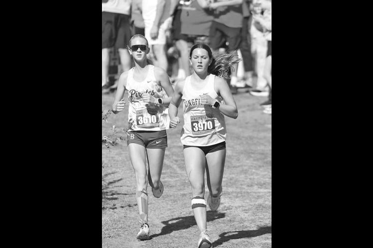 KHS SENIOR Mattie Slezickey (right) makes her way down a decline just beyond the mid-point of Saturday’s Class 4A state cross country meet. [KT&amp;FP Staff Photo]