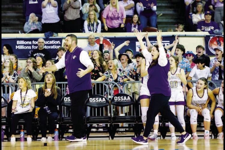 Okarche girls basketball coaches Scott Tahah (left) and Brett Tahah react after a pivotal play during Tuesday’s Class A state basketball quarterfinals. Okarche upset No. 5 Amber-Pocasset 50-42 to advance to the semifinals. The win came just two days aft