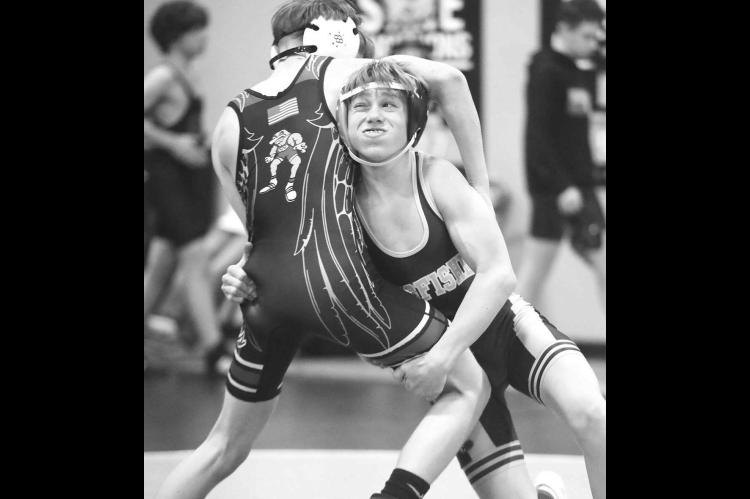 KINGFISHER’S Steel Snodgrass makes a takedown attempt during one of his Friday matches at the Western Conference Wrestling Tournament. Snodgrass placed fifth at 112 pounds in the junior high division. [KT&amp;FP Staff Photo]