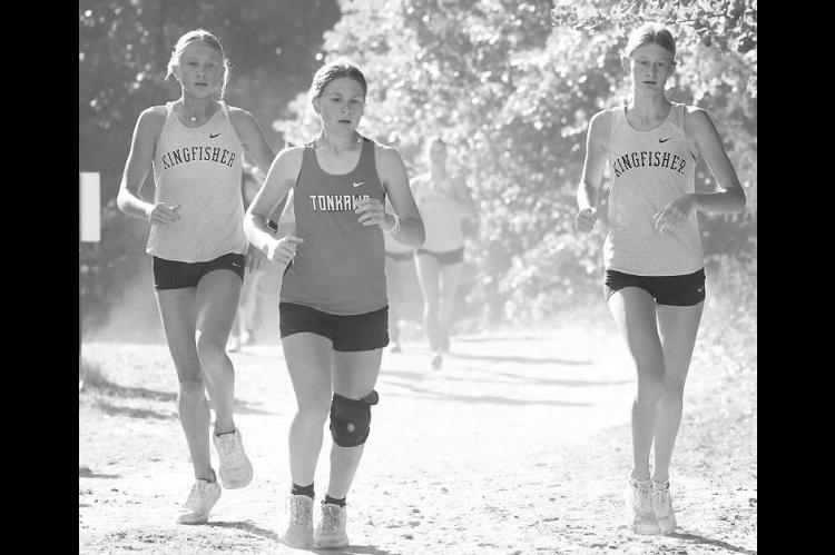 KHS SOPHOMORES Ryann Farrar (left) and Hinsley Brodrick (right) approach the halfway point of their race in Watonga last Saturday. Brodrick placed 34th and Farrar 40th out of 84 runners as KHS placed fourth as a team. [KT&amp;FP Staff Photo]
