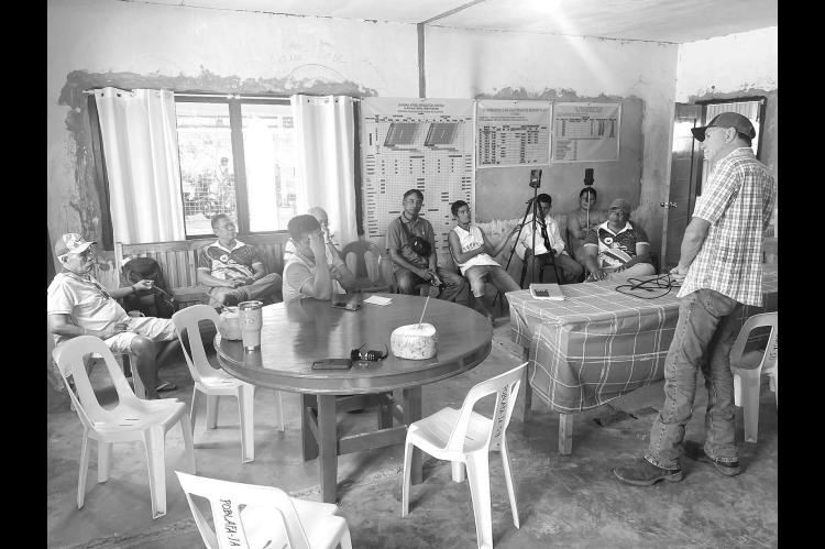 BISON CO-OP President Todd Vaverka of Hennessey, far right, talks with a group of rice farmers in the Philippines during his current trip. The farmers are interested in forming a cooperative to help them better control prices at harvest time. [Photo provided]