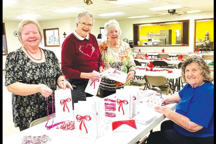 HENNESSEY’S GOLDEN Eagles teamed up to put together Valentine’s Day gifts and personalized cards for the residents of the Hennessey Care Center. Pictured are (standing from left) Denise Brim, Pansy Wheeler and LaNita Killian. Seated is Nancy Fisher who is writing out the Valentine’s cards. The group’s president, Shirley Koons, donated all of the items. [KT&amp;FP photo by Barb Walter]