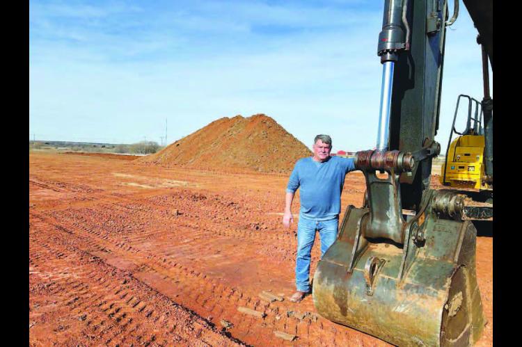 DISTRICT 2 Commissioner Mike Sparks stands on an eight-acre tract of land that was donated to the county by the Town of Hennessey. The land will allow for the expansion of the equipment yard for District 2. [KT&amp;FP Staff Photo]