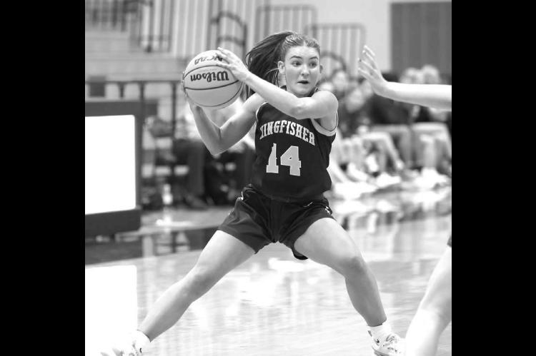 TAITYM WALKER surveys the court during Kingfisher’s regional championship win over Mannford. Walker’s defense helped stifle Mannford’s best scoring threat much of the night. [Photo by Russell Stitt/www.stitt.smugmug.com]