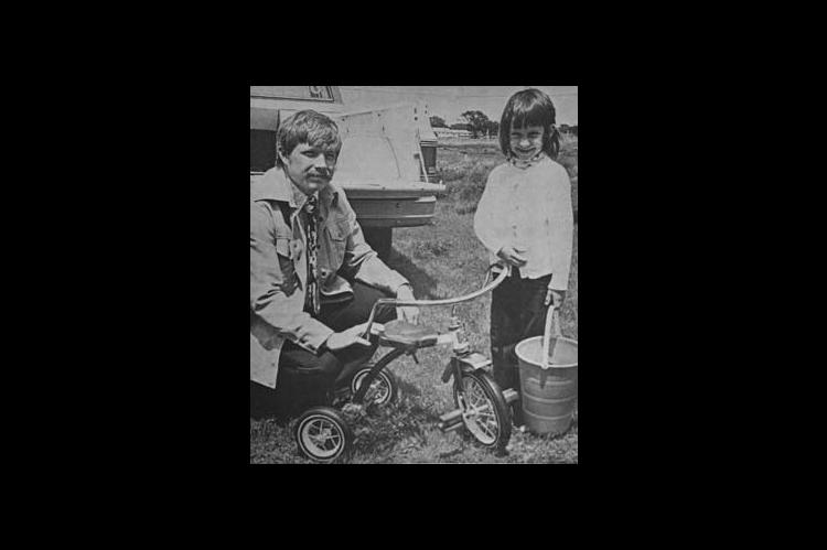 KIMBERLY HAWKINS, six, daughter of Mr. and Mrs. Jimmy Hawkins, northwest of Kingfisher, was the winner of a tricycle in the Jaycee Easter Egg Hunt held Sunday, April 25. Presenting the tricycle is Jerry Copeland, president of the Jaycee chapter. (Times, April 29, 1976)