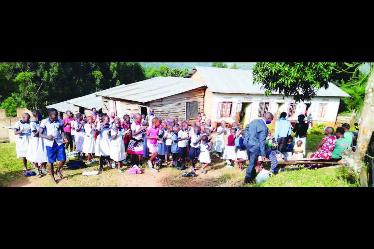 SCHOOL CHILDREN (pictured above and below right) stand outside the Divine Mercy School in Kanungu, Uganda. The school serves 180 children who are either orphaned or from impoverished households. The local Rotary Club is attempting to gain sponsorships for some of those children so they can continue to attend the school. [Photos provided by John Bosco Agaba of Uganda]
