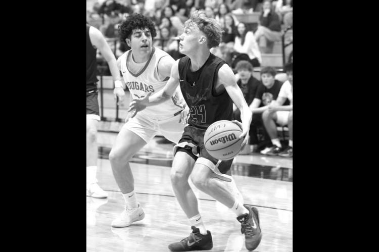 CROSTON MARTIN dribbles down the baseline during the Jackets’ regional final against North Rock Creek. [Photo by Russell Stitt/www.stitt.smugmug.com]