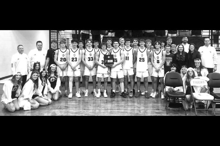 OKARCHE BASKETBALL players, coaches and cheerleaders pose with the Class A area championship hardware they won last Friday after defeating Red Oak 88-51. [Photo provided]