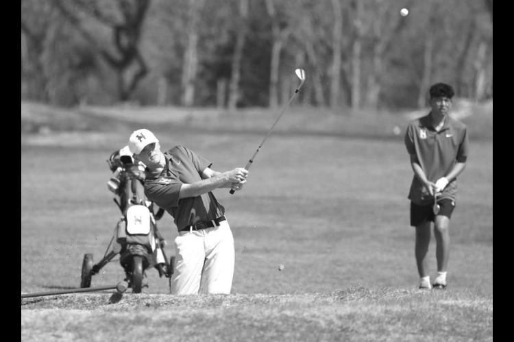 HENNESSEY’S Taylor Ladwig watches his chip shot on the 11th hole during Monday’s tournament. He parred the hole en route to a 73, good for third place overall. [KT&amp;FP Staff Photo]