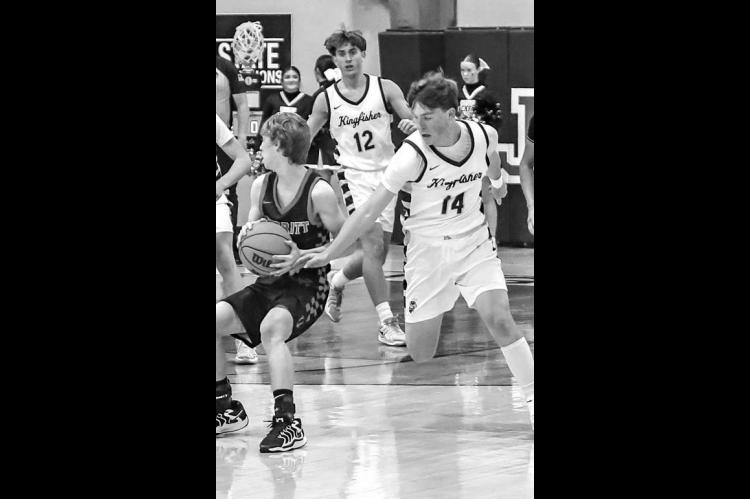 HAYES WHITE (14) goes for a steal against Merritt in a Tuesday matchup. White scored 18 points and six steals in the contest. [Photo by Chris Simon/www.simon-sports-photos. smugmug.com]