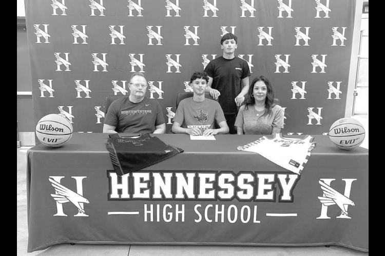 RANGER RIDING – Hennessey’s Camdyn Richardson, seated center, signed last Wednesday to continue his basketball career at Northwestern Oklahoma State University. Among the family members joining him were his parents Brian and Jenny Richardson. Standing