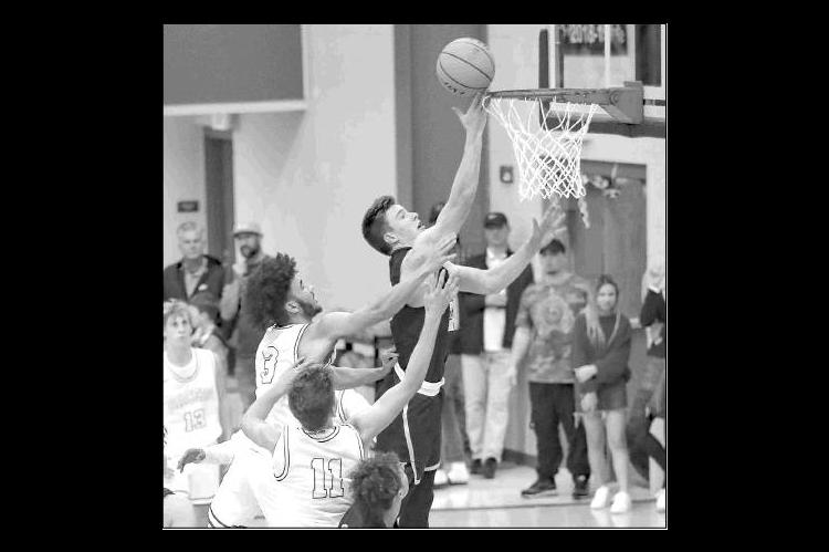 KHS JUNIOR Matthew Stone lays in a bucket during his team’s season-opening win at Newcastle last week. Stone had 17 points and 15 rebounds for second-ranked KHS.             [Photo by Chris                           Simon/www.simon-sports-photos.s