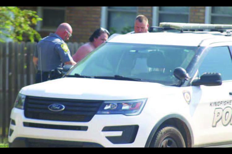 PREVIOUS ARREST – Lila Aghaebrahimi is pictured being arrested in August 2023 on a complaint of drug trafficking. She was arrested at her home, which is near two elementary schools in Kingfisher, by then KPD Lt. Dustin Brodrick (left) and then-Chief Dav