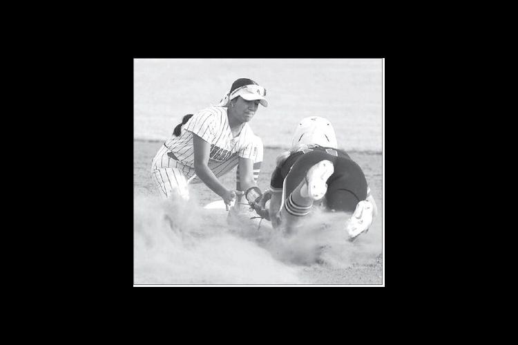 DOVER SHORTSTOP Dayanara Padilla applies a tag after a throw from catcher Maeli Turner to catch a Carney runner attempting to steal second base. [KT&amp;FP Staff Photo]