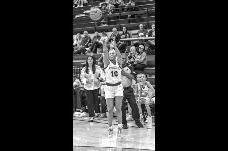 REESE ROOF launches a 3-pointer Thursday as her coach Taylor Young and teammates look on. Roof made four treys and scored 20 points in the Lady Jackets’ regional victory. [Photo by Chris Simon/www. simon-sports-photos.smugmug.com]