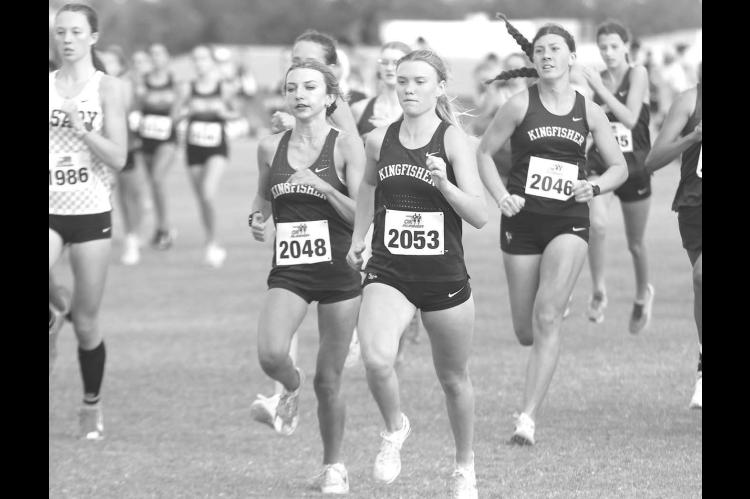 KINGFISHER’S Lily Lunsford (2048), Scout Snodgrass (2053) and Harper Evans (2046) try to make their way to the lead of the pack at the start of Thursday’s cross country race at Heritage Hall. All three runners medaled for KHS as Snodgrass won the individual honor and the team placed second. [KT&FP Staff Photo]