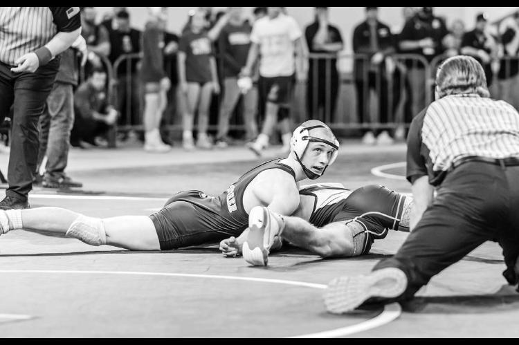 KHS SOPHOMORE Jaxon Sheppard looks at the official as he tries to pin Kolbe Bargas of Vinita during their 132-pound wrestle-in match at the Class 3A state tournament on Thursday. Sheppard didn’t get the pin, but he did get a 20-15 victory to move into t