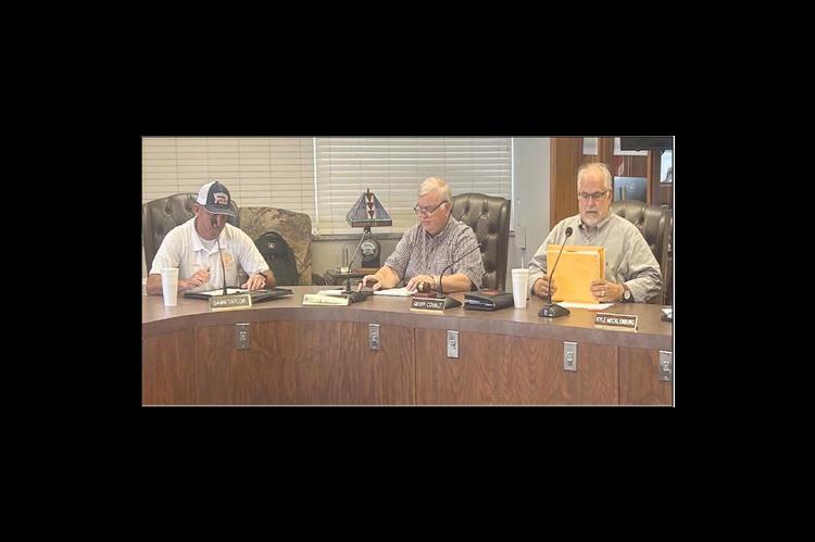 KINGFISHER FIRE Station construction bids were opened Thursday afternoon at Kingfisher City Hall, with Ray Holliday of BRW Architects, Inc., right, announcing the bid amounts from the seven bidding companies and verifying that the proper bidding procedure