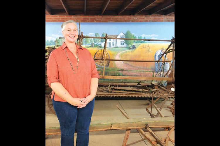 NEW CHISHOLM Executive Director Kimberly Prack stands in front of one of the exhibits of the Kingfisher museum. She recently took over the role from Jason Harris. [KT&amp;FP Staff Photo]
