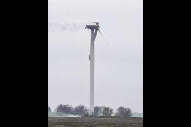 FIRE AND SMOKE emanate from the damaged blade and nacelle of a wind turbine northeast of Dover after a lightning strike early last Friday morning. [Photo by Jeremy Ingle/KT&amp;FP]