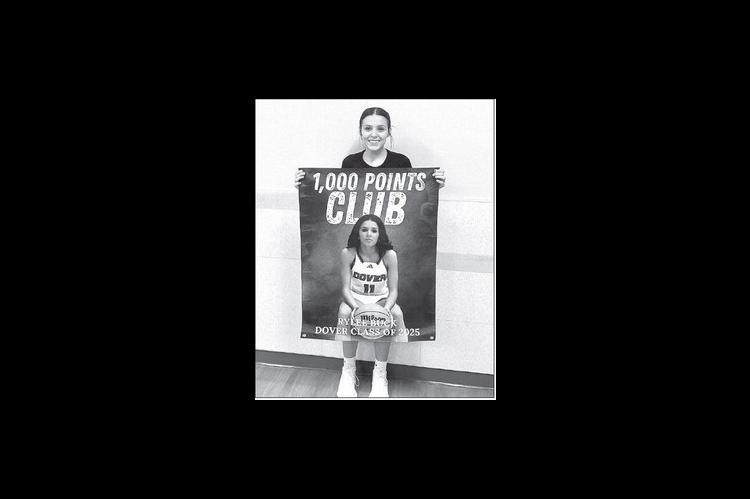 RYLEE BUCK was presented a banner after surpassing 1,000 career points last Friday. [Photo provided]