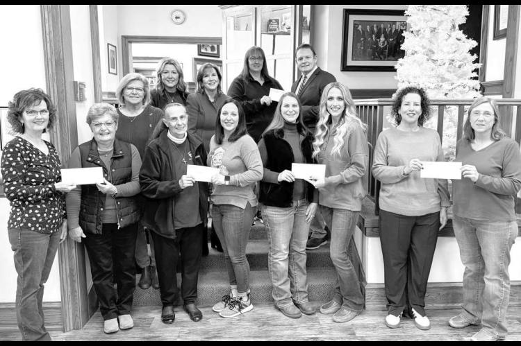 The First Bank of Okarche made donations this holiday season to the Center of Family Love, Holy Trinity Catholic School, Kingfisher County Food Bank, Okarche Christmas Connection, Kingfisher Meals on Wheels and The Lord’s Harvest in El Reno. Pictured on