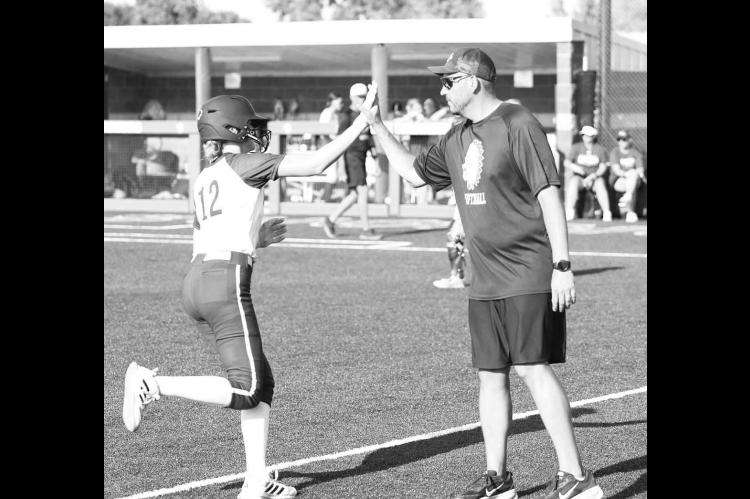 OKARCHE INFIELDER Kinley Pruett high-fives coach Scott Tahah after hitting a home run earlier this season. Pruett, Tahah and the rest of the Lady Warriors qualified for state by winning their regional last week. [KT&amp;FP Staff Photo]