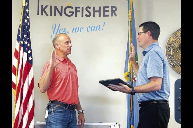 DEJA VU – City Attorney Jared Harrison (right) swears in Jeff Wittrock to a city commission seat during Monday’s meeting. Wittrock was first sworn in last April to fill an unexpired seat and was the only person to file for the open seat earlier this y