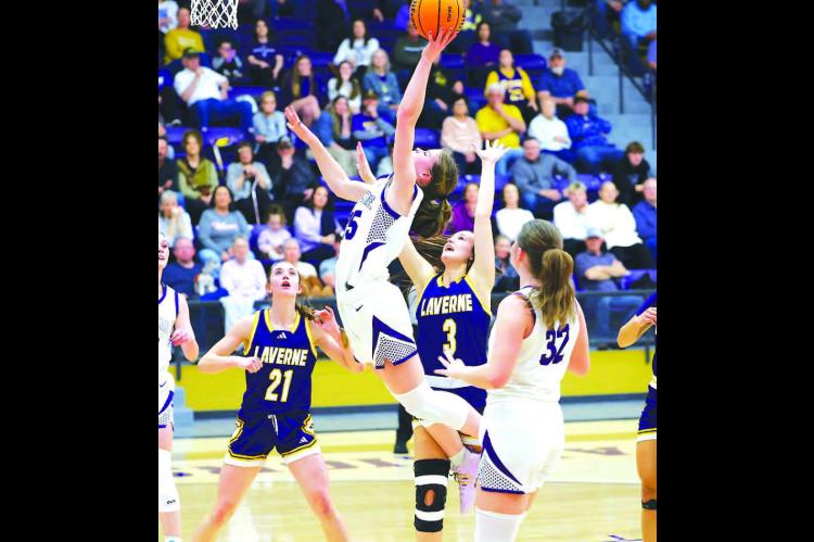 OKARCHE’s Callie Cramer (25) goes up for a shot in the lane during her team’s win over Laverne on Tuesday. Cramer scored 10 points as the Lady Warriors moved into the regional finals. [KT&amp;FP Staff Photo]