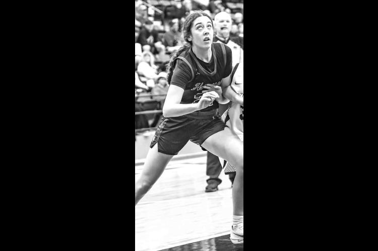 HENNESSEY’S Clare Munroe battles for position during a Three Rivers Conference Tournament semifinal game against Okarche. Munroe scored 24 points last Tuesday in her team’s victory against Watonga. [Photo by Chris Simon/ www.simon-sports-photos.smugmu