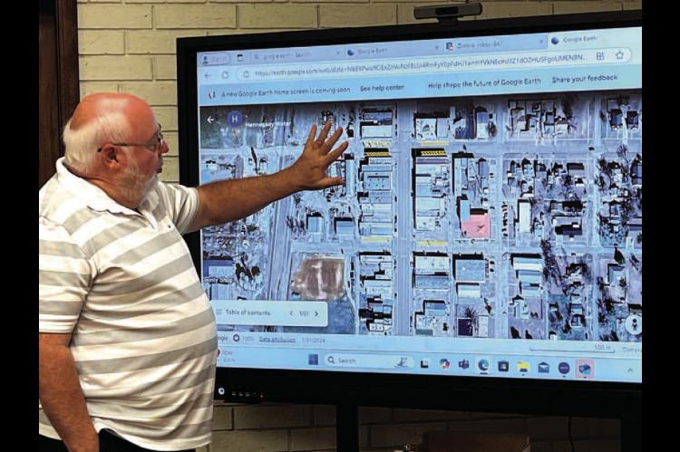 HENNESSEY TOWN Trustee Bert Gritz points out map locations for downtown parking and signage issues during a special meeting of the town board Wednesday, Oct. 23, at Town Hall. [Photo by Barb Walter]