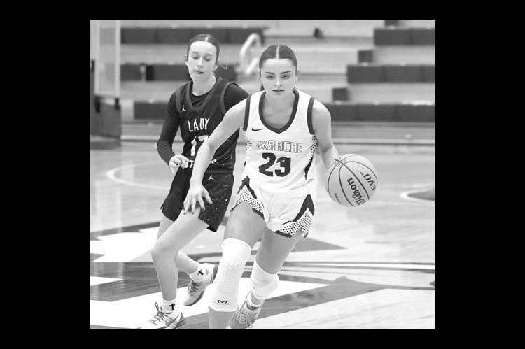 KATE BAUSTERT dribbles it up the floor during Okarche’s area title game loss to Am-Po. The Lady Warriors rebounded to win Saturday and advance to state. [KT&amp;FP Staff Photo]