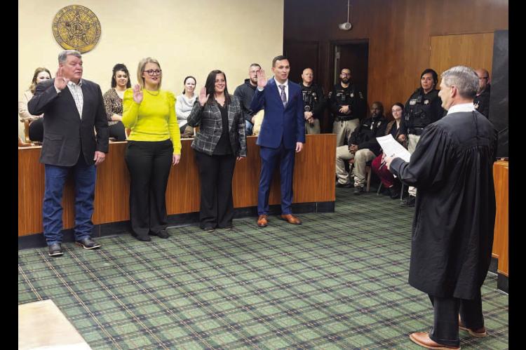 I DO SOLEMNLY SWEAR....Pictured above are, from left, Mike Sparks, Lauren Stroh, Emily Lee and Aarron Pitts taking the oath for their respective offices during a swearing-in ceremony held Thursday at the Kingfisher County Courthouse. The ceremony was held in the courtroom and conducted by Associate District Judge Lance Schneiter. 