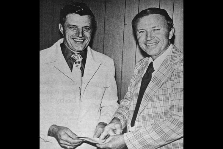 JOHHNIE RUHL, left, general manager for the Pioneer Telephone Cooperative based in Kingfi sher and serving 50 communities, is shown here talking with D. James Blakely of Wharton, Texas, who was the speaker at the 23rd annual meeting held here last week. Ruhl is telling Dr. Blakely that the cooperative, largest in the United States, had a record year last year and now has 21,470 subscriber-members.