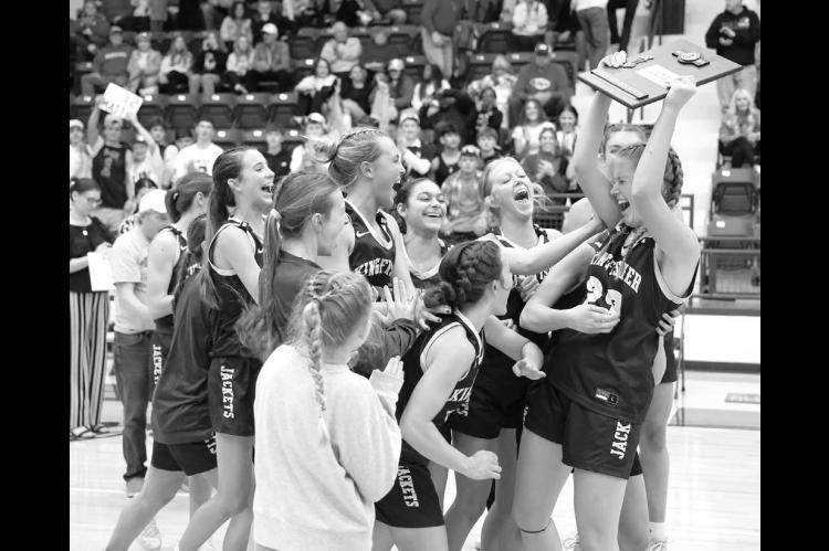 KINGFISHER GIRLS basketball players swarm the team’s lone senior Raegan Snider after she collected the Class 4A girls area consolation championship trophy Saturday night in Stroud. [Photo by Russell Stitt/www.stitt.smugmug.com]