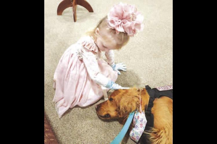 MARLEY AND BAILEY – Marley Cooper of Kingfisher pets Bailey, the Emmanuel Lutheran Church’s comfort dog. Marley is the daughter of Cammeron and Kari Cooper and granddaughter of Mark and Lynn Wendt. The church is hosting Bailey’s annual 5K and fun ru