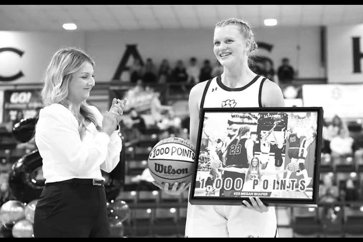 CASHION ASSISTANT coach Ashley Sears congratulates Megan Shafer as she’s recognized for surpassing 1,000 career points. Shafer is also nearing 1,000 career rebounds. [Photo provided]