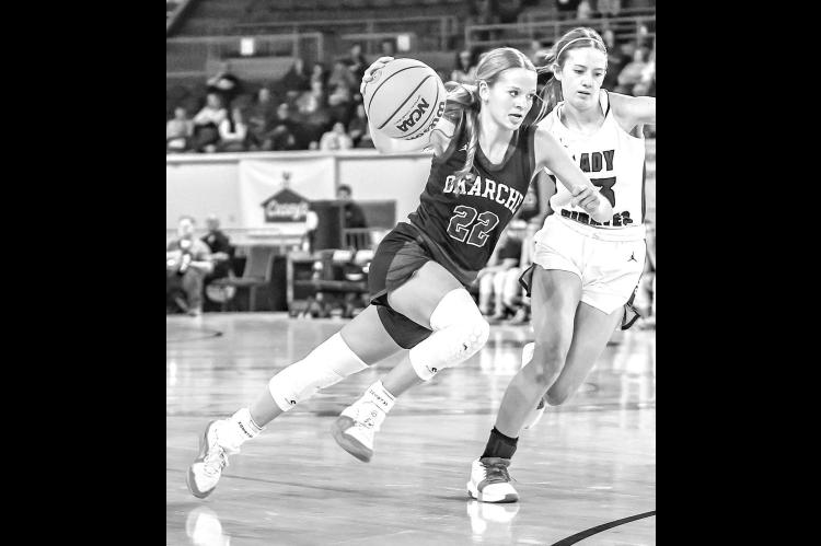 OKARCHE SENIOR Avery Schieber drives to the bucket during the first half of her team’s Class A semifinal against Cyril. Schieber scored on the play to give the Lady Warriors a 12-9 lead. [Photo by Chris Simon/www.simon-sports-photos.smugmug. com]