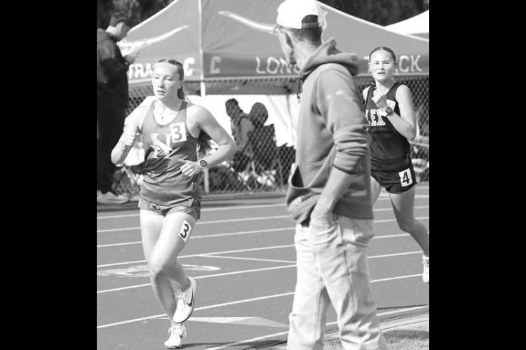 JULIANNE MATOUSEK competes in the two-mile run during Saturday’s regional meet. The Hennessey freshman quali[ fied for state in that event and two others. [KT&amp;FP Staff Photo]