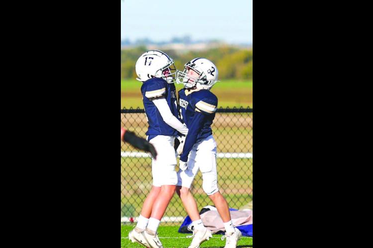 TOUCHDOWN JACKETS! – Kingfisher’s Bryson Black, left, and Cooper Myers celebrate after a touchdown Saturday in their team’s 30-8 victory over Crossings Christian in their fifth and sixth grade league championship. For more information, see Page 2A. 