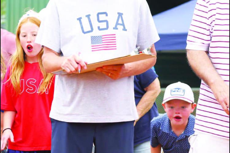 LOCKED IN – Maitlyn and Sam Tollefson were completely invested in the turtle races during the 2025 Fourth of July celebration at Kingfisher Park. The turtle races and other longstanding traditions return for this year’s celebration Saturday. [KT&amp;FP Staff Photo]
