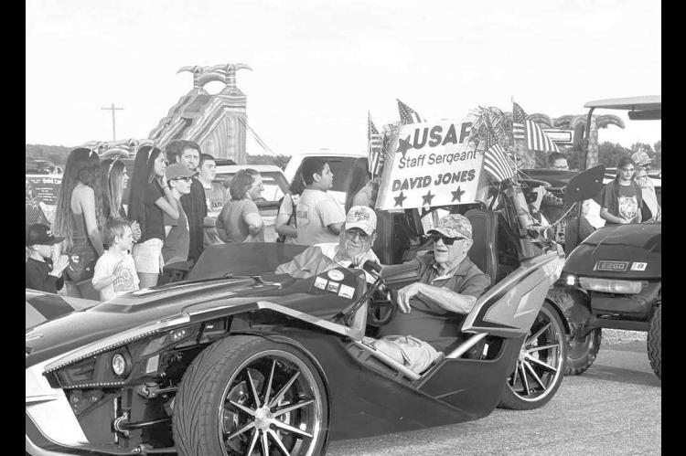 NICE RIDE – During last Thursday evening’s Independence Day parade in Hennessey, Grand Marshal David Jones talks with his driver, Don Hennigh, a retired Hennessey Oklahoma Highway Patrol trooper who is escorting Jones in a Polaris Slingshot. [Photo provided by David’s daughter, Trisha Scott]