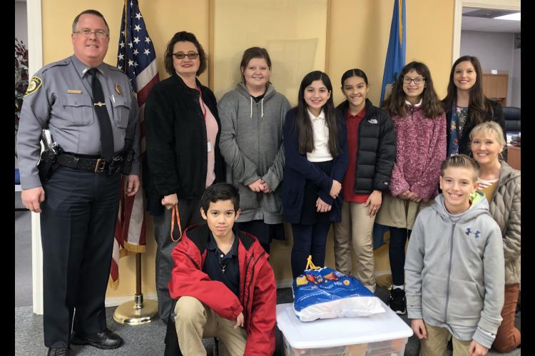 Pictured at the delivery to Kingfisher Police Department are, from left: front row, Alexander Garcia, Noah Hall and Sandy Murray; and back row, KPD Chief Dennis Baker, Sherry Pringnitz, Hannah Borelli, Mia Franco, Karen Munoz, Hailey Crosswhite and Makyla
