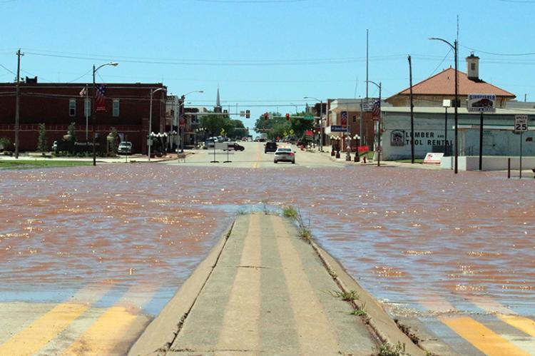 FAMILIAR SIGHT — U.S. 81 was closed on the north side of Kingfisher as water continued to rise Tuesday afternoon. Local creeks had already exceeded their flood stages and were expected to crest late Tuesday. The Cimarron River was predicted to crest about 9 a.m. Wednesday. [KT&FP Staff Photo]