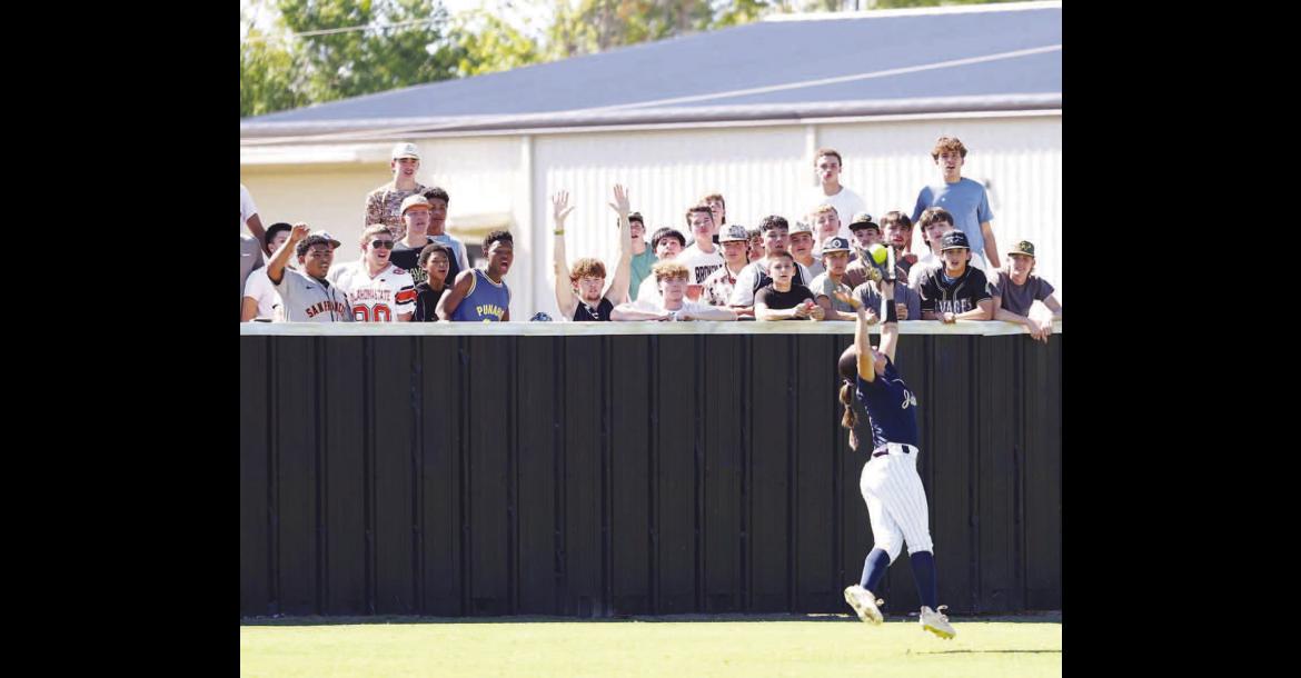 LILIANA GARRAMONE makes a leaping catch in left field in front of a group of Broken Bow students during Kingfisher’s 7-2 victory on Wednesday in the opener of a Class 4A softball super regional. [KT&amp;FP Staff Photo]