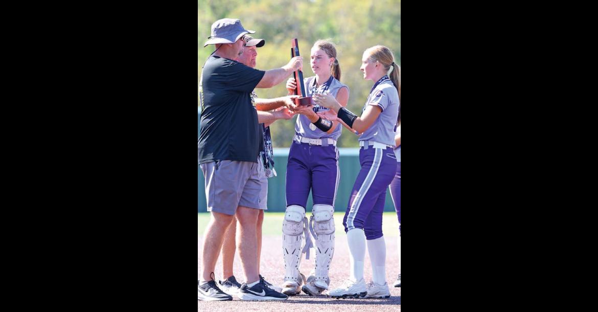 OKARCHE SUPERINTENDENT Josh Sumrall and OHS Principal G.W. Parham present the Class A softball state runner-up trophy to Callie Cramer and Katie Parham (far right) after last Saturday’s championship game in Shawnee. [KT&FP Staff Photo]