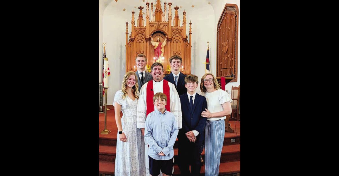 STARK FAMILY – Clint Stark is the new pastor at St. John’s Lutheran Church in Okarche. The Stark family has recently moved to Okarche from Texas. Pictured with Clint and his wife Brianne (far right) at the church are their son Benjamin (front row), daughter Mary (far left) and sons Simeon (middle row), Henry and Wyatt (back row). [Photo provided]