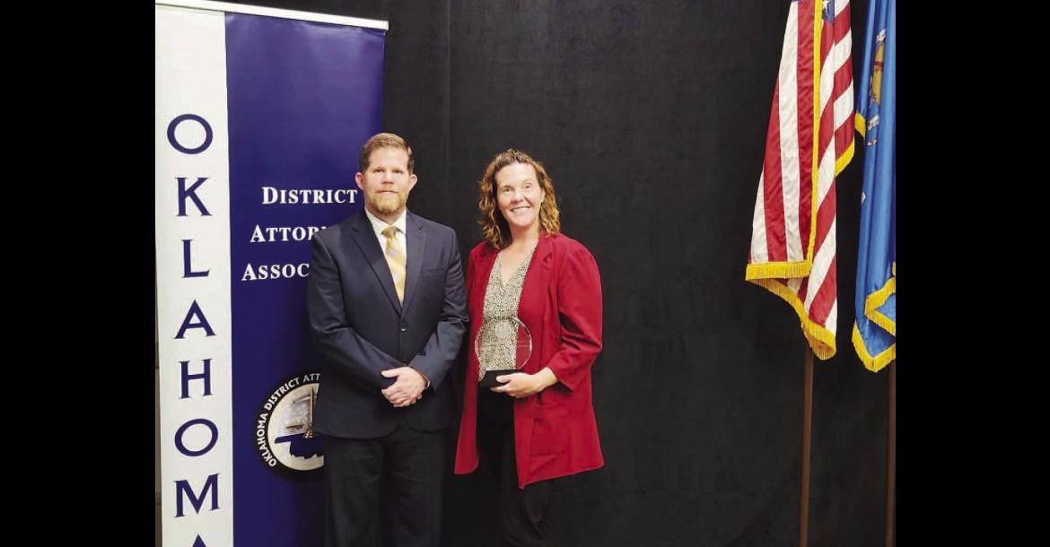 OUTSTANDING WORK – Lisa Benson was recently presented the Outstanding Administrative Professional Employee by the ODAA at its Summer Conference. The director of programs for District 4 is pictured with District Attorney Tommy Humphries after winning the honor. [Photo provided]