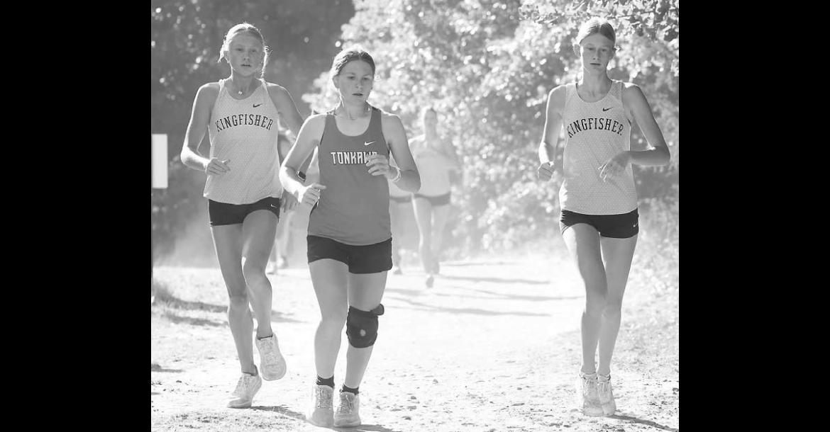 KHS SOPHOMORES Ryann Farrar (left) and Hinsley Brodrick (right) approach the halfway point of their race in Watonga last Saturday. Brodrick placed 34th and Farrar 40th out of 84 runners as KHS placed fourth as a team. [KT&amp;FP Staff Photo]